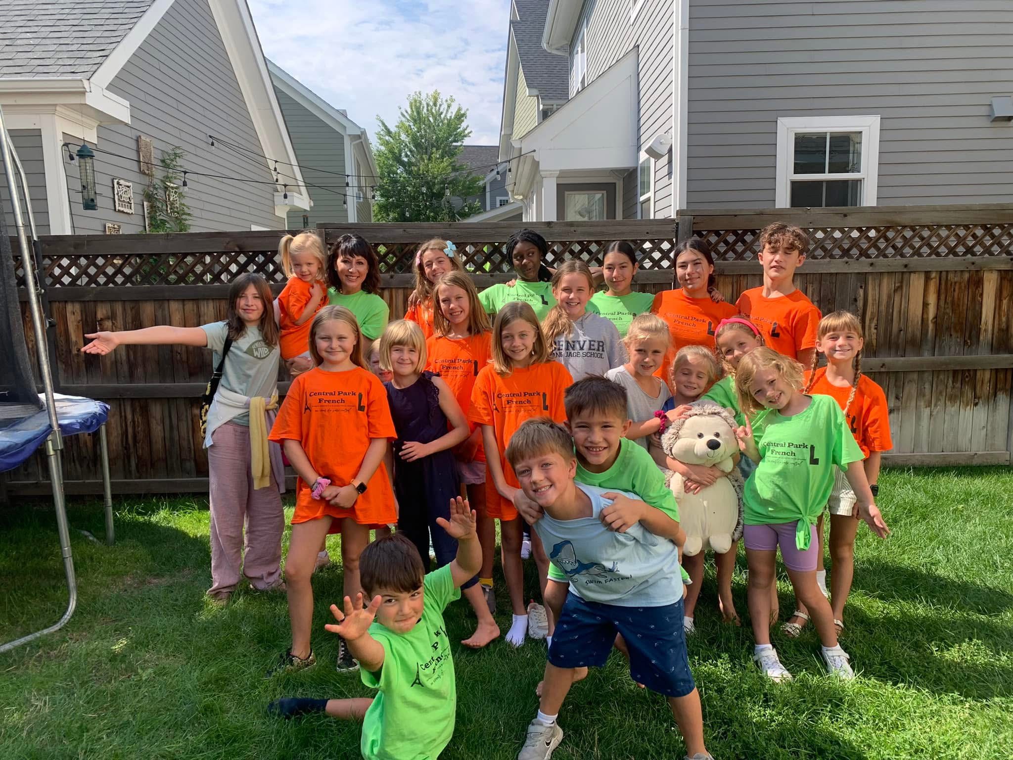 A French instructor leading a joyful children's language activity in Denver